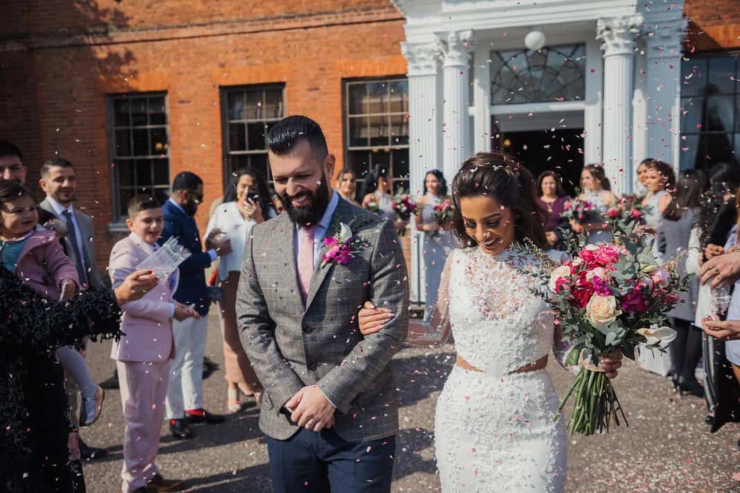 Happy wedding couple outside manor house