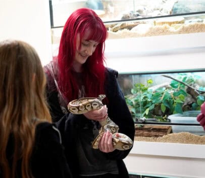 Student holding a snake